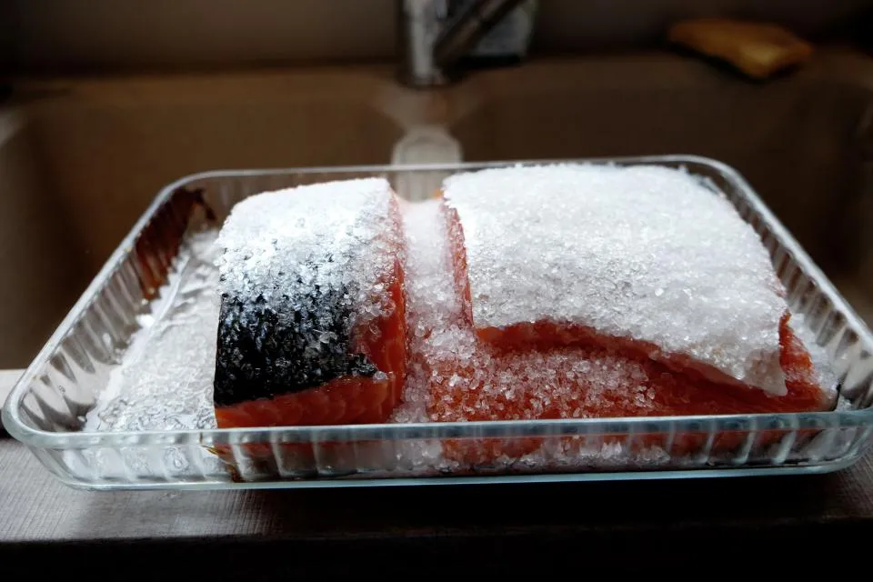Fish fillets packed in crushed ice in a clear tray